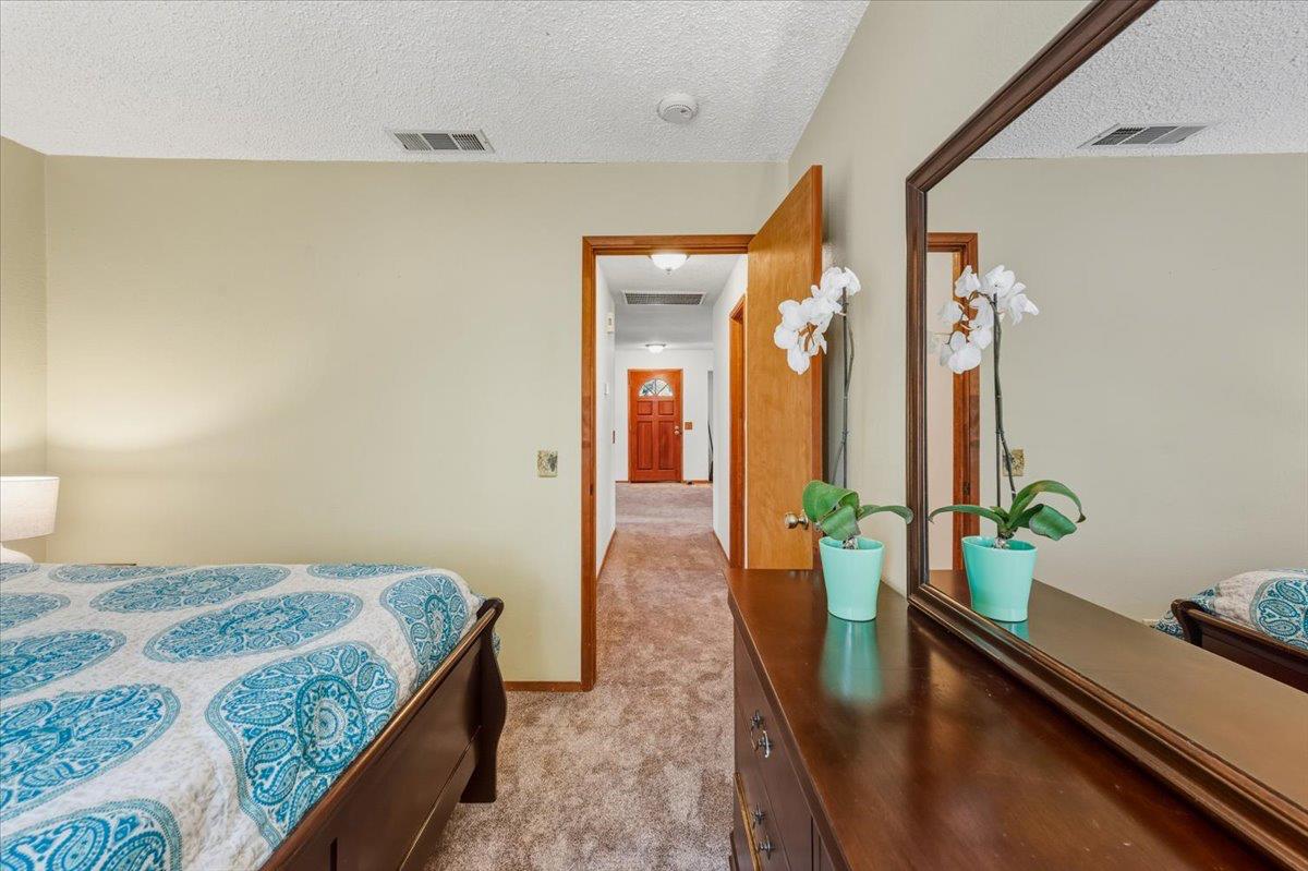 12486 Valley View Road Nevada City, CA 95959 - Photo 20 of 48 a bedroom with a bed and wooden floor