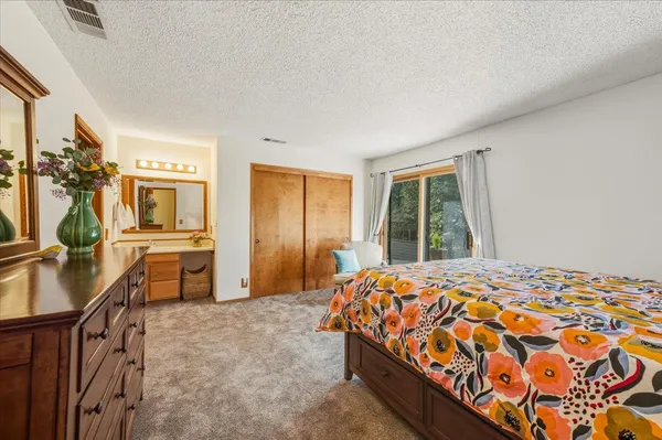 a bedroom with a bed a table and chair