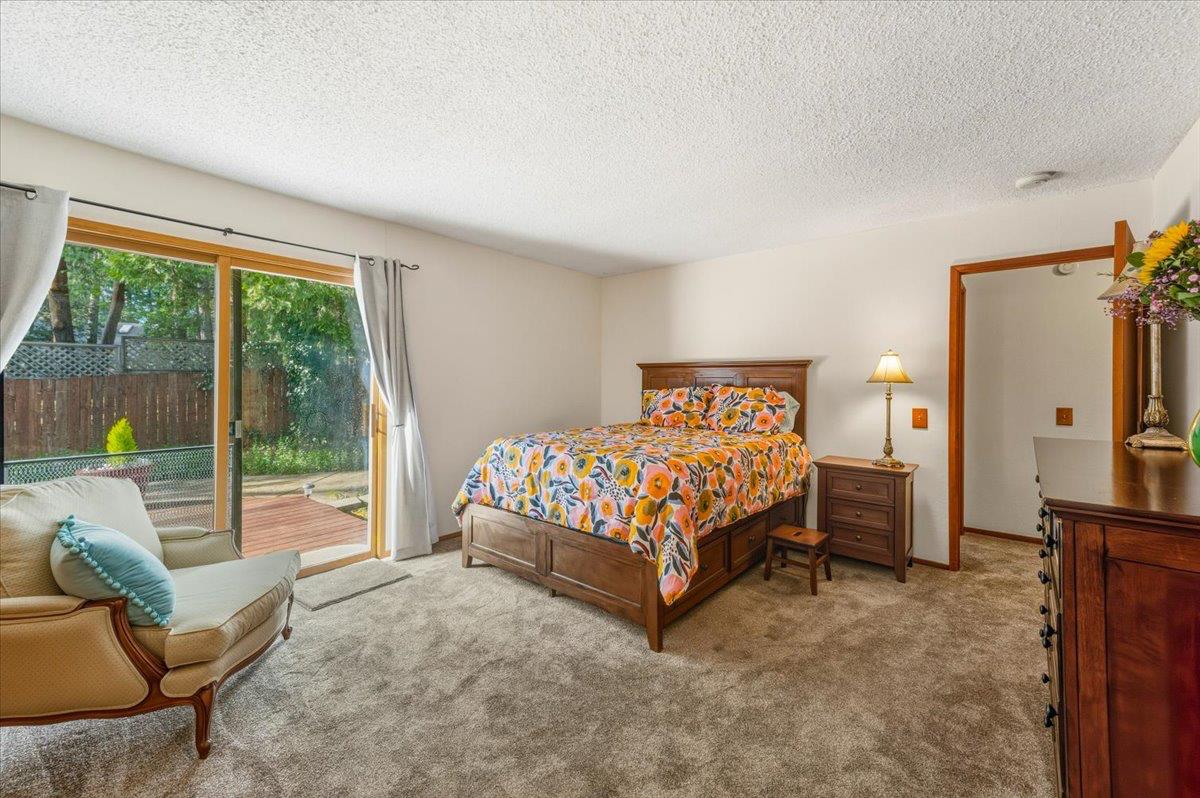 12486 Valley View Road Nevada City, CA 95959 - Photo 22 of 48 a bedroom with a bed and glass walk in closet