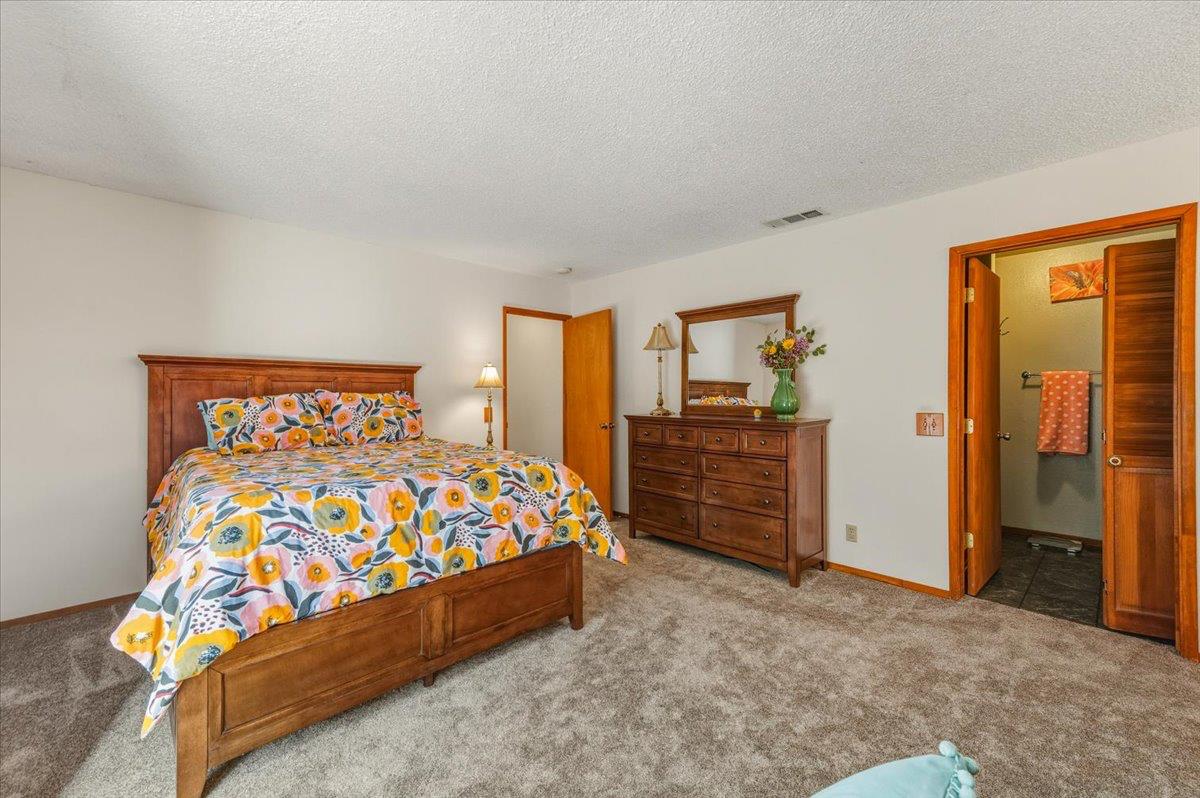 12486 Valley View Road Nevada City, CA 95959 - Photo 23 of 48 a large bed sitting in a bedroom next to a cabinet