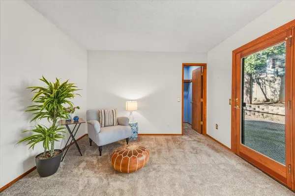 a living room with furniture and large windows