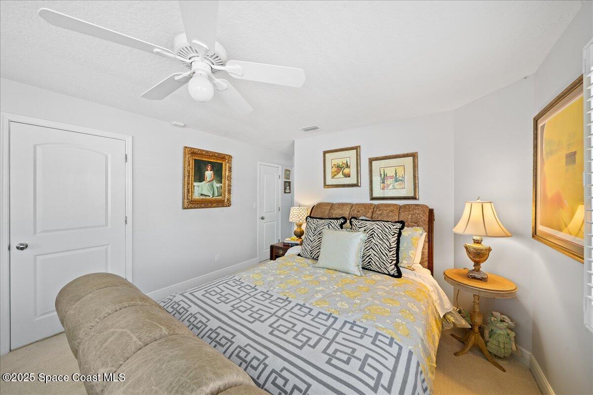 254 Seaview Street, Unit B Melbourne Beach, FL 32951 - Photo 54 of 77 a bedroom with a bed and wooden floor