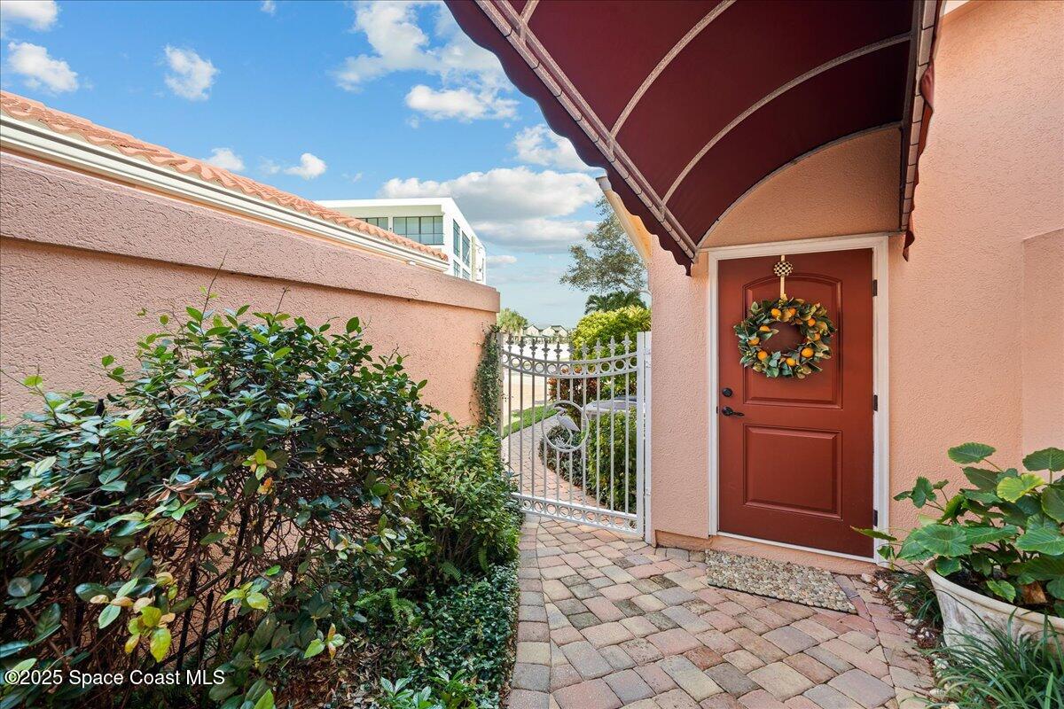 254 Seaview Street, Unit B Melbourne Beach, FL 32951 - Photo 8 of 74 Garage Door with Covered Walkway