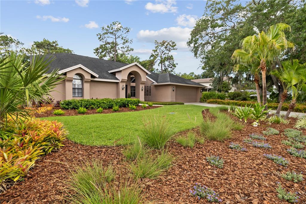 3372 Brian Road South Palm Harbor, FL 34685 - Photo 3 of 45 a front view of a house with garden