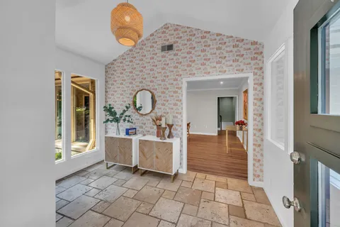 a kitchen with stainless steel appliances granite countertop a sink a stove and a refrigerator