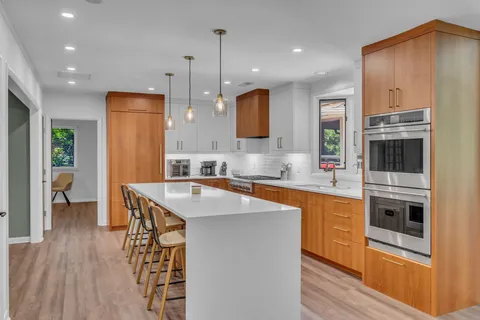 a living room with kitchen island furniture and a large window