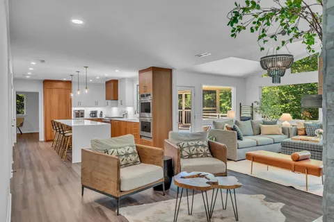 a living room with furniture and a chandelier