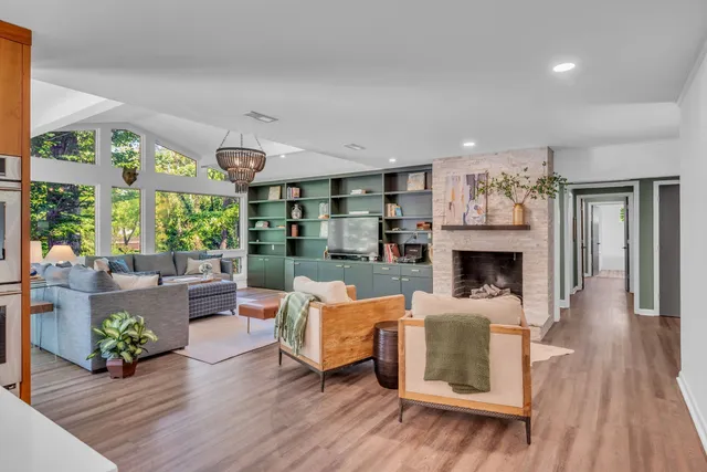 a front view of a house with swimming pool having outdoor seating