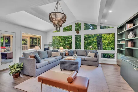 a view of a house with a yard and sitting area