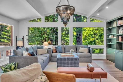 a view of a house with backyard sitting area and garden