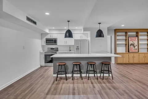 a view of a living room with wooden floor and fence