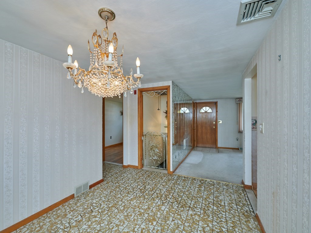 200 Hardy Pond Road Waltham, MA 02451 - Photo 11 of 28 a view of a hallway with wooden floor and chandelier