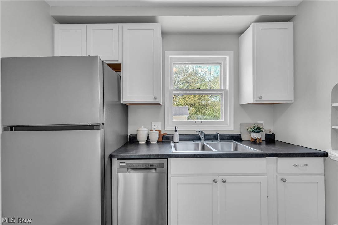 1828 South Green Road Cleveland, OH 44121 - Photo 5 of 30 Kitchen with appliances with stainless steel finishes, white cabinets, and sink
