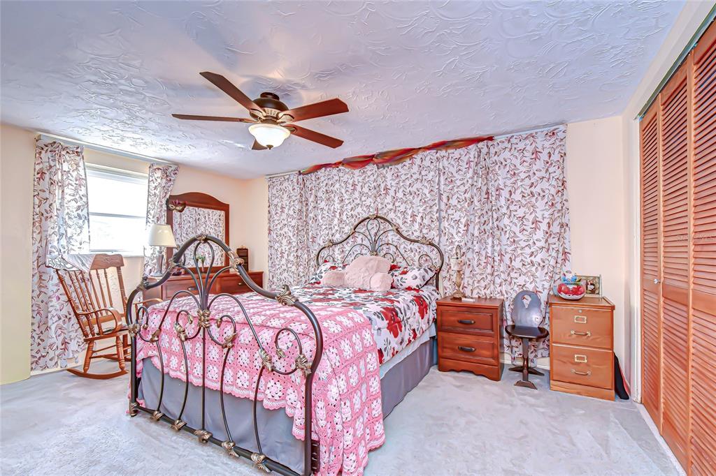 2128 Shannon Drive Holiday, FL 34690 - Photo 14 of 21 a bedroom with two beds and a chandelier
