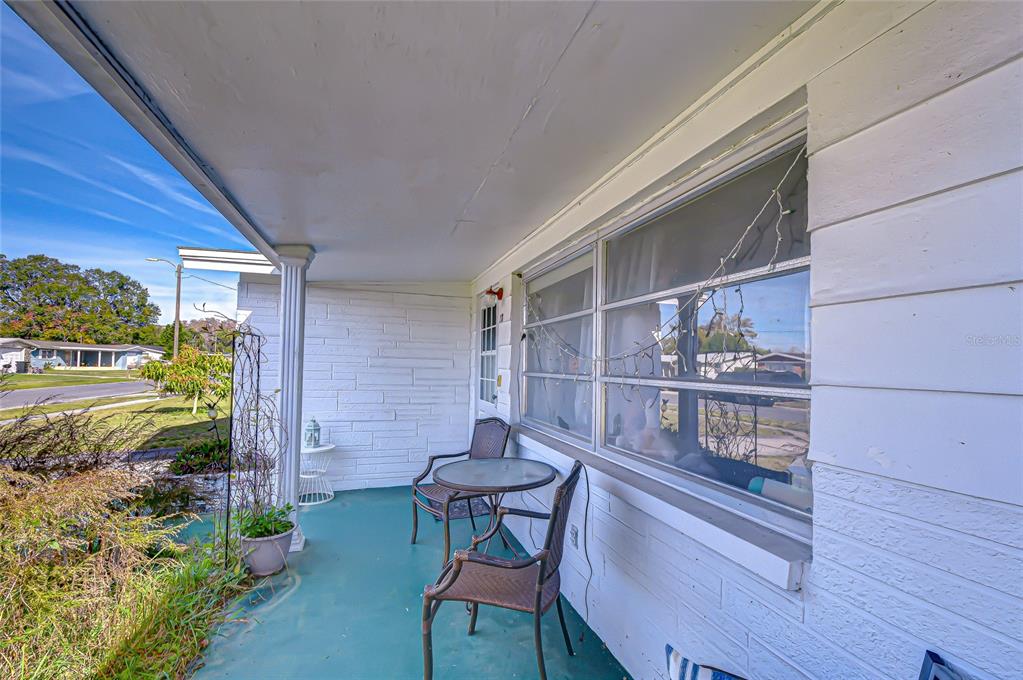 2128 Shannon Drive Holiday, FL 34690 - Photo 2 of 21 a backyard of a house with table and chairs