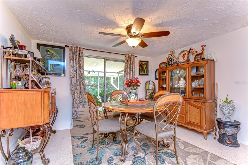 2128 Shannon Drive Holiday, FL 34690 - Photo 6 of 21 a view of a dining room with furniture and a chandelier