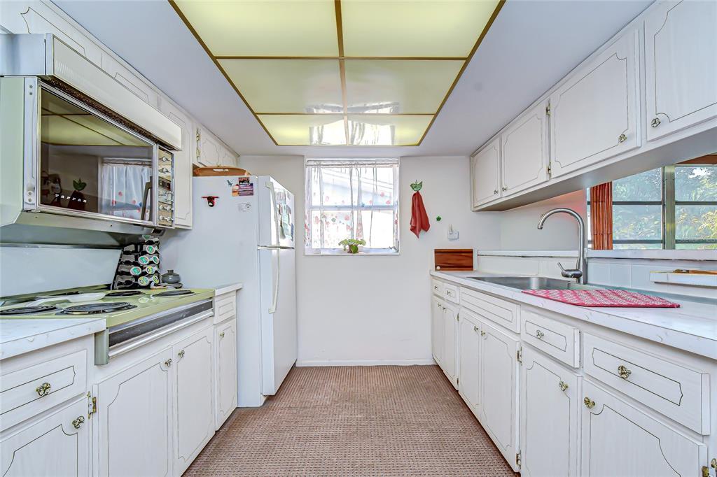 2128 Shannon Drive Holiday, FL 34690 - Photo 7 of 21 a kitchen with a sink window and cabinets