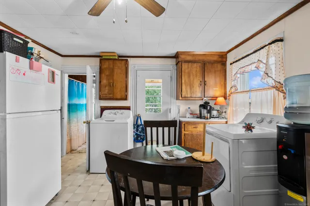 a kitchen that has a table and chairs in it