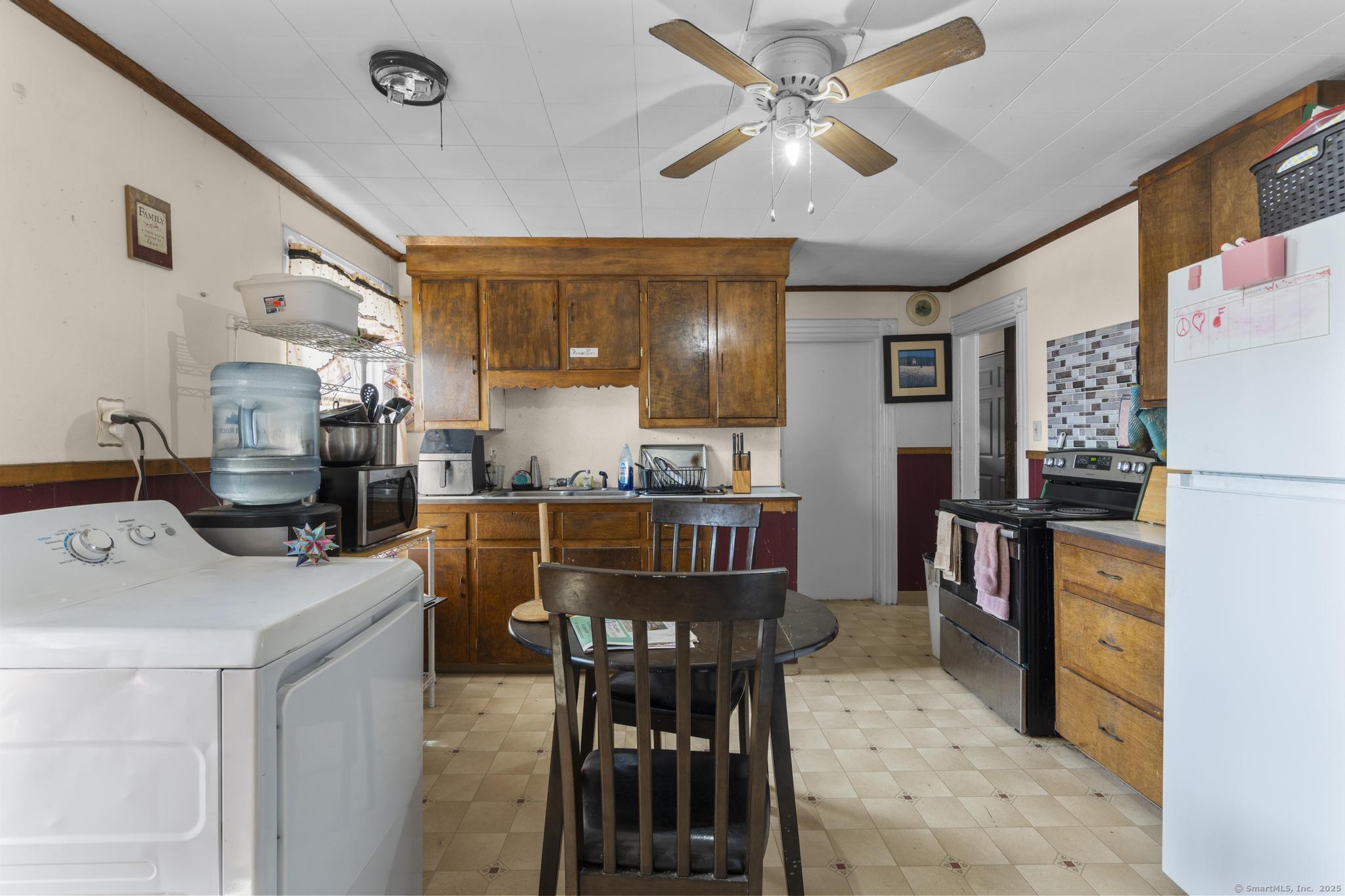 615 South Main Street Torrington, CT 06790 - Photo 12 of 18 a dining hall with stainless steel appliances kitchen island granite countertop furniture and a dining table