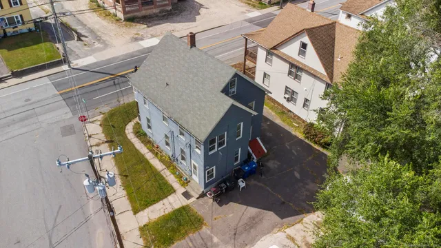 an aerial view of a house with a yard