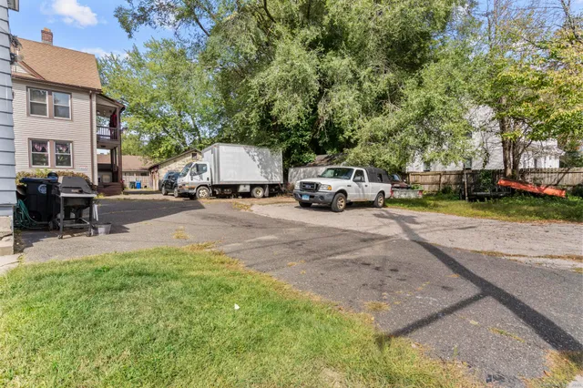 a view of a yard with cars