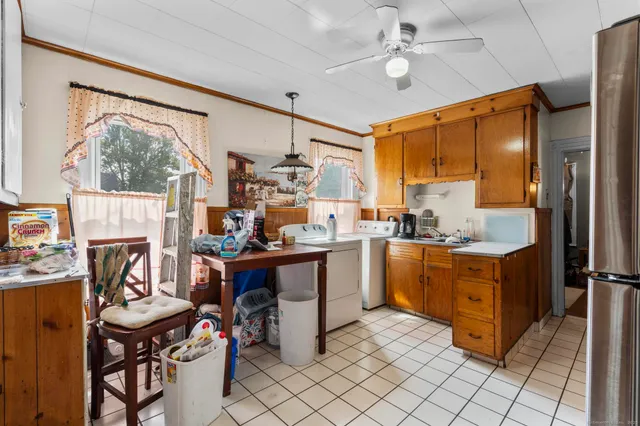 a room with stainless steel appliances kitchen island granite countertop furniture and a fireplace