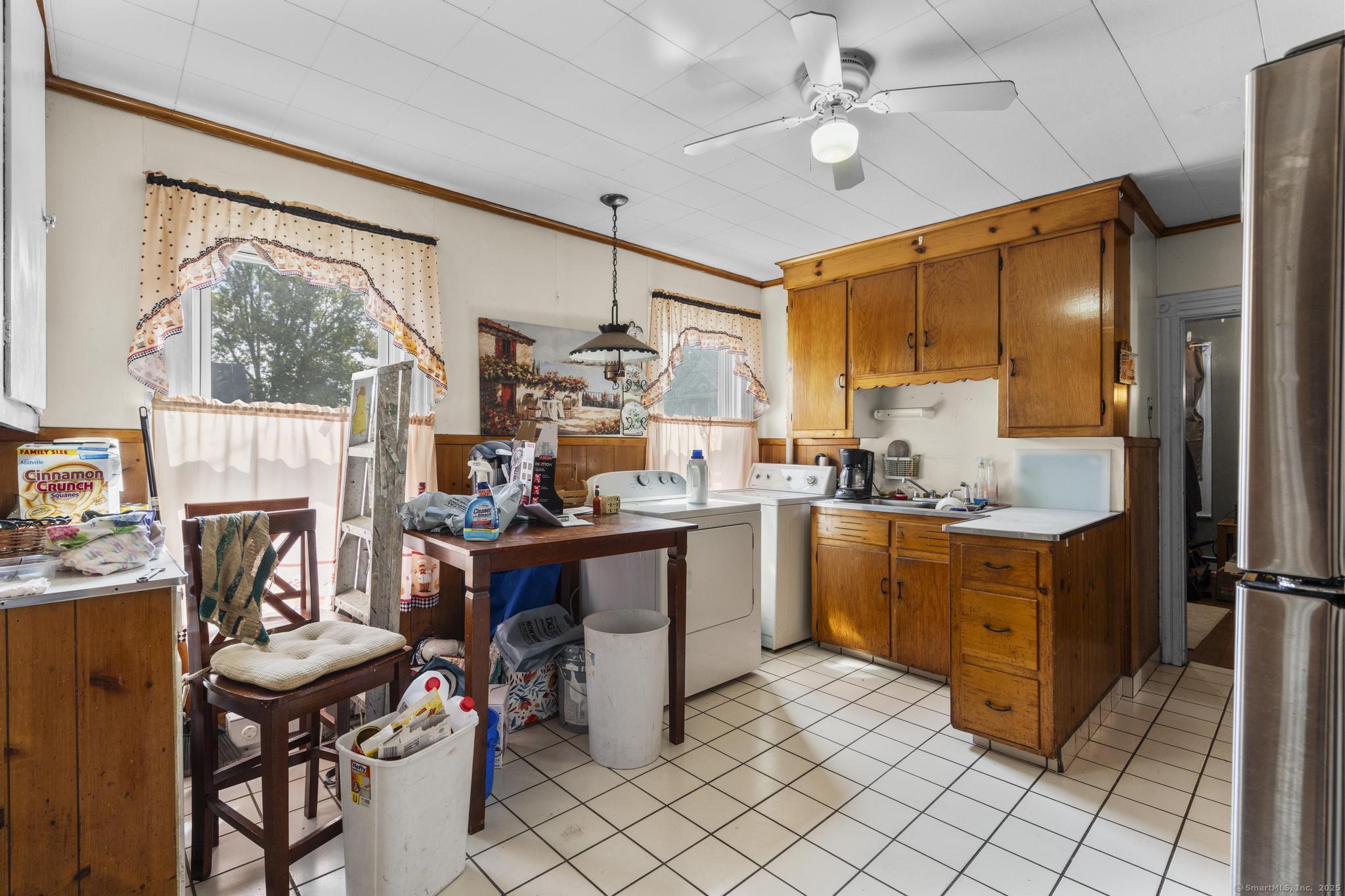 615 South Main Street Torrington, CT 06790 - Photo 5 of 18 a room with stainless steel appliances kitchen island granite countertop furniture and a fireplace