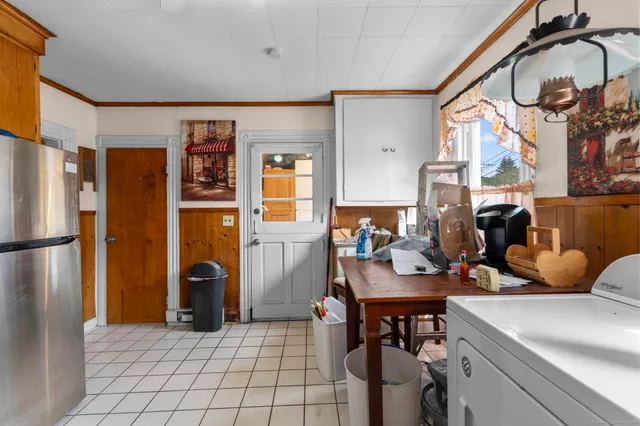 a kitchen with stainless steel appliances granite countertop a dining table and chairs