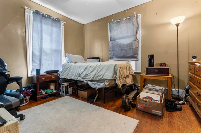 a bed sitting in a bedroom next to a window