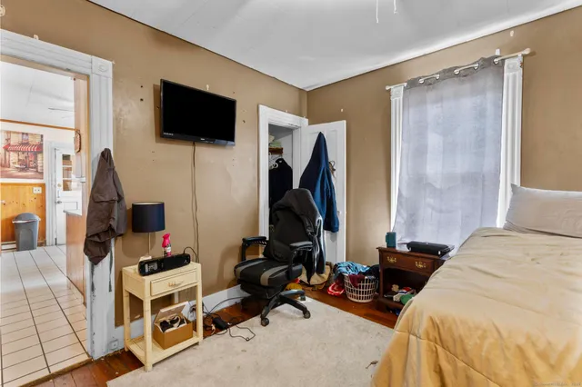 a bedroom with a bed and a flat screen tv