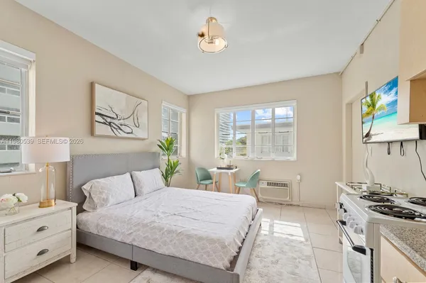 a spacious bedroom with a bed and a potted plant
