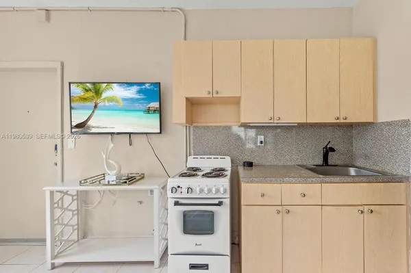 a kitchen with stainless steel appliances white cabinets and a stove top oven