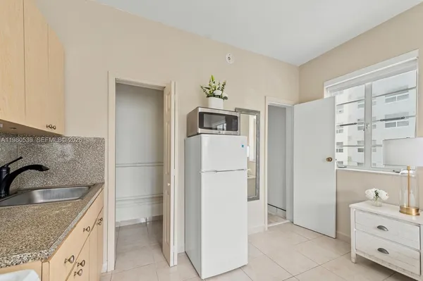 a kitchen that has a sink cabinets counter space and appliances