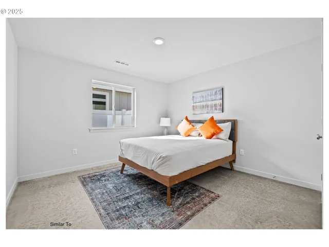 a bedroom with a bed and window