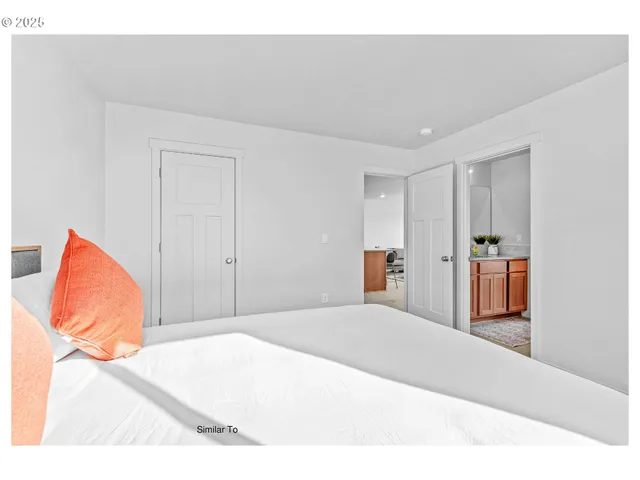 a bedroom with a bed and a painting