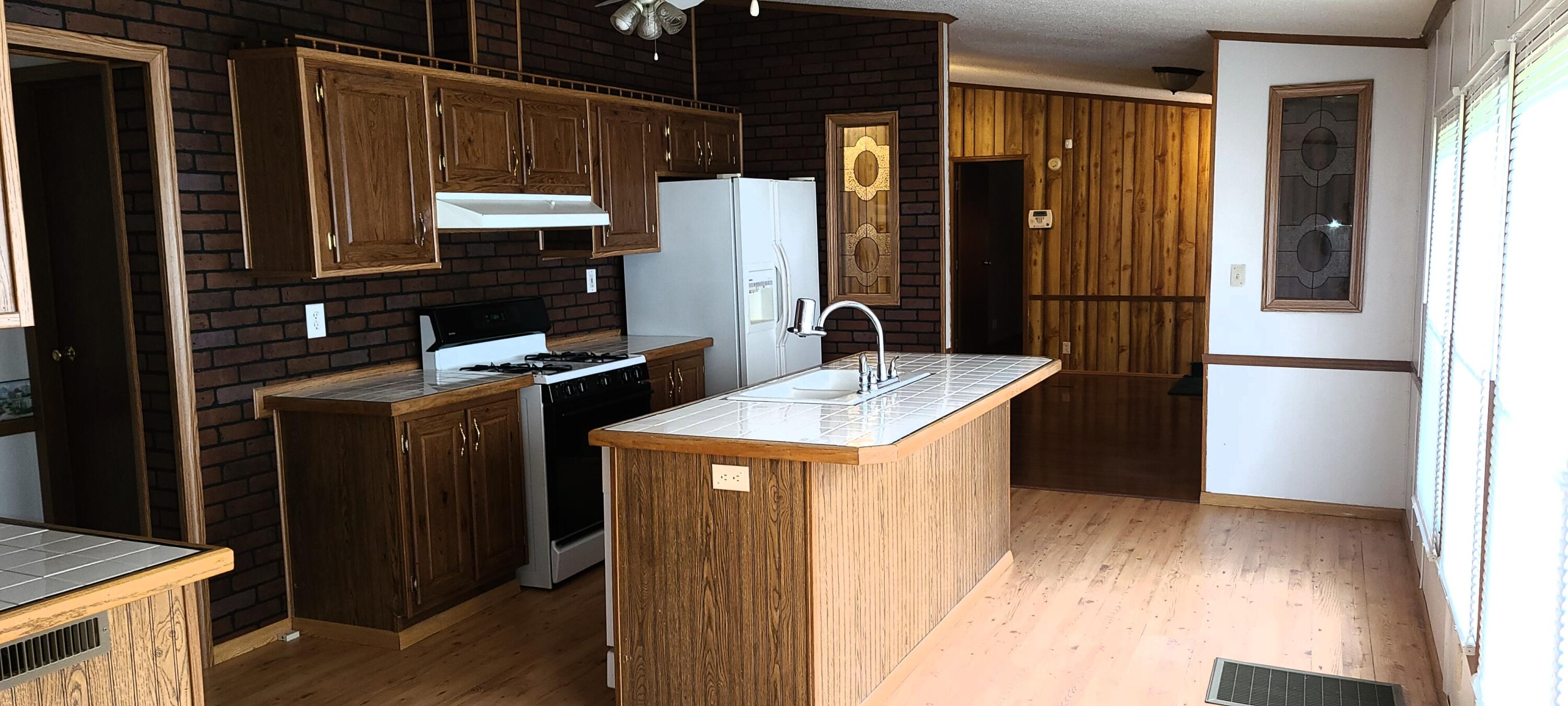 1898 Laird Road Crestview, FL 32539 - Photo 8 of 15 a kitchen view with granite countertop a sink and a refrigerator