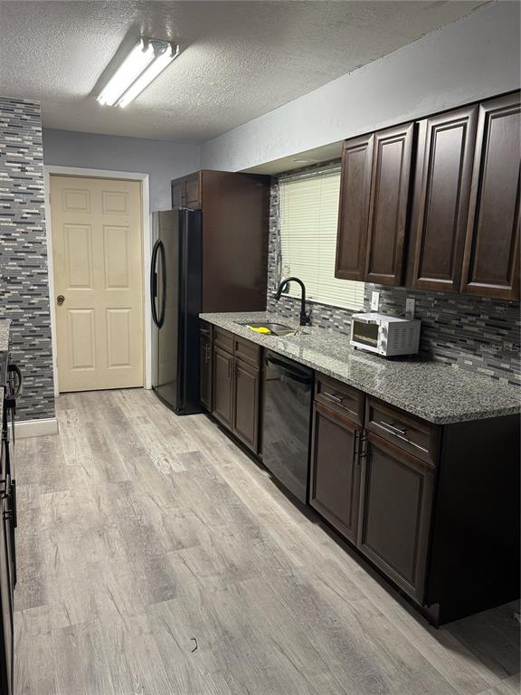 5295 Southeast 28th Street Ocala, FL 34480 - Photo 5 of 11 a kitchen with stainless steel appliances granite countertop a sink stove and refrigerator