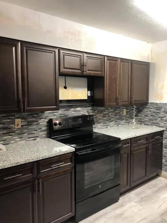 5295 Southeast 28th Street Ocala, FL 34480 - Photo 6 of 11 a kitchen with stainless steel appliances wooden cabinets and a sink