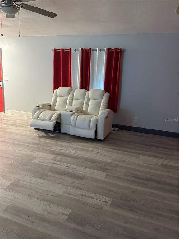 5295 Southeast 28th Street Ocala, FL 34480 - Photo 7 of 11 a living room with furniture and a wooden floor