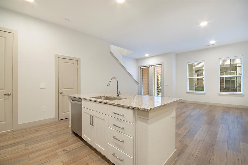 4700 West Spring Creek Parkway, Unit 10102 Plano, TX 75024 - Photo 1 of 20 a hall with cabinets and wooden floor