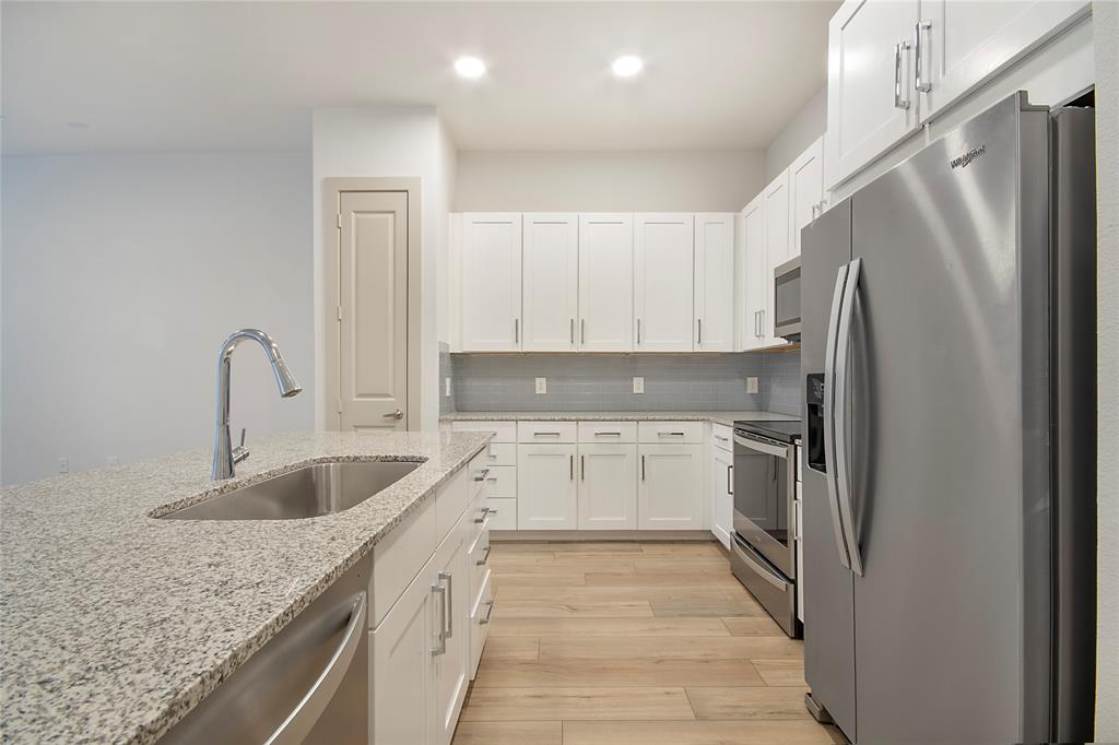 4700 West Spring Creek Parkway, Unit 10102 Plano, TX 75024 - Photo 4 of 20 a kitchen with refrigerator sink and cabinets