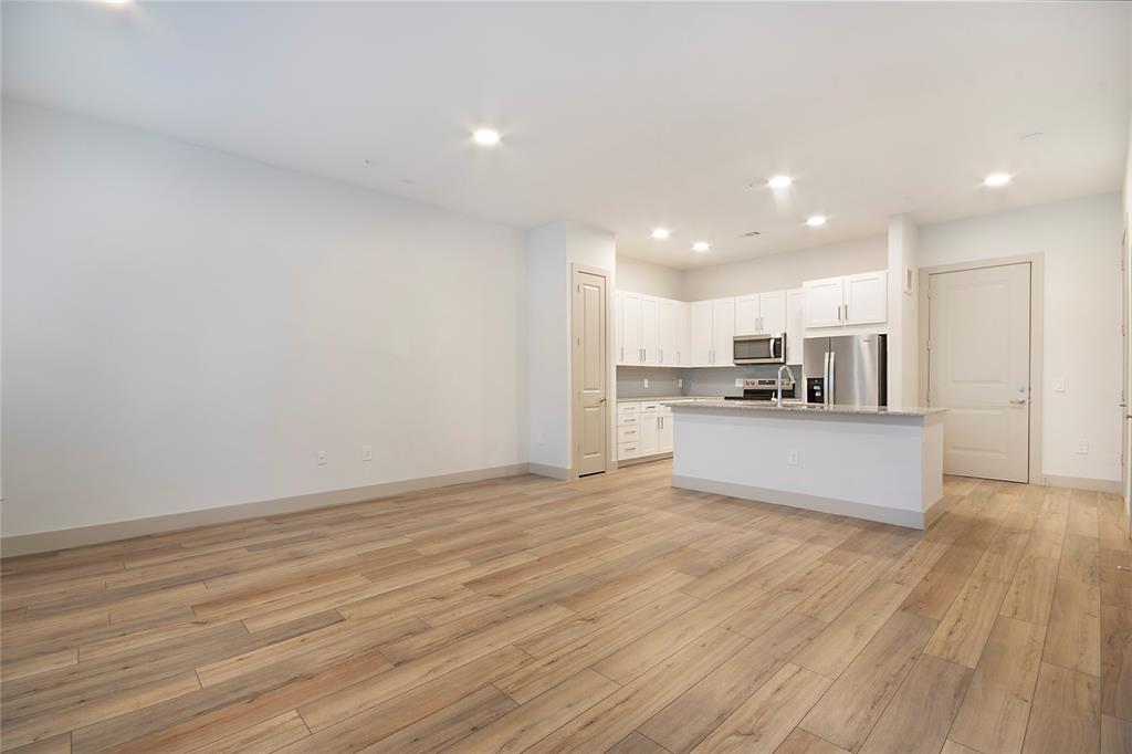 4700 West Spring Creek Parkway, Unit 10102 Plano, TX 75024 - Photo 6 of 20 a view of kitchen with kitchen island wooden floor center island and stainless steel appliances