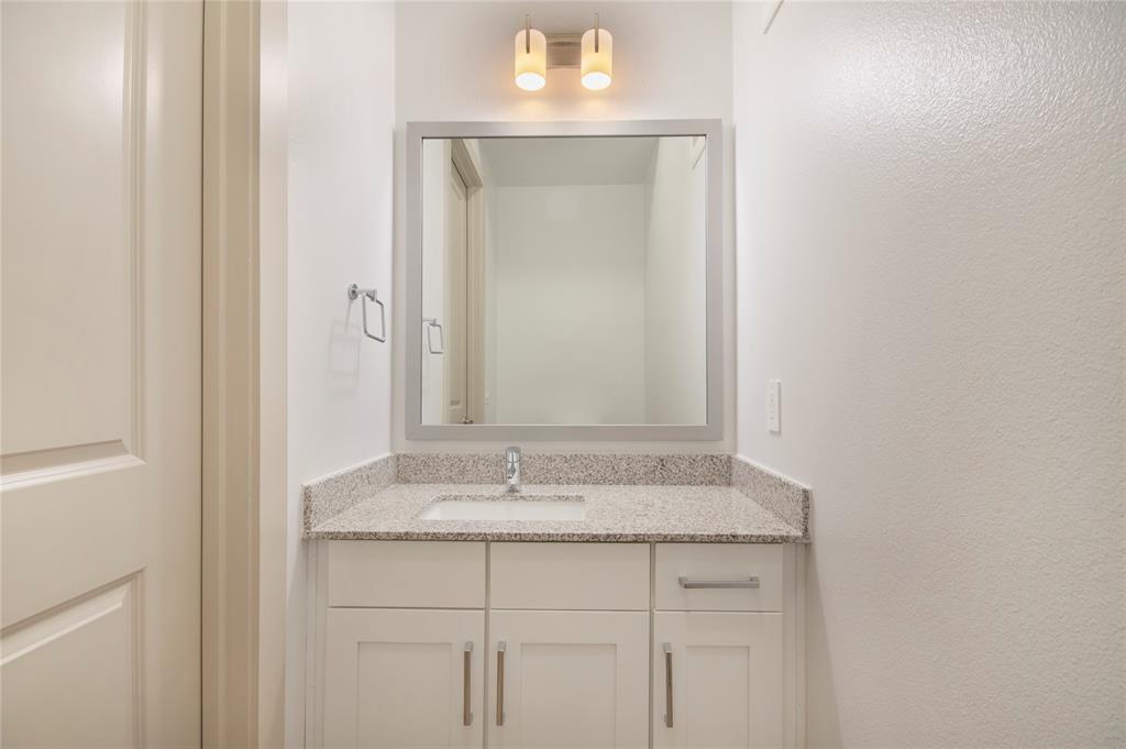 4700 West Spring Creek Parkway, Unit 10102 Plano, TX 75024 - Photo 10 of 20 a bathroom with a sink and a mirror