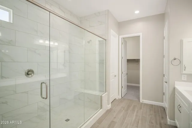 a bathroom with a shower and a glass door