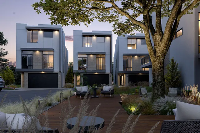 a front view of a house with yard and trees