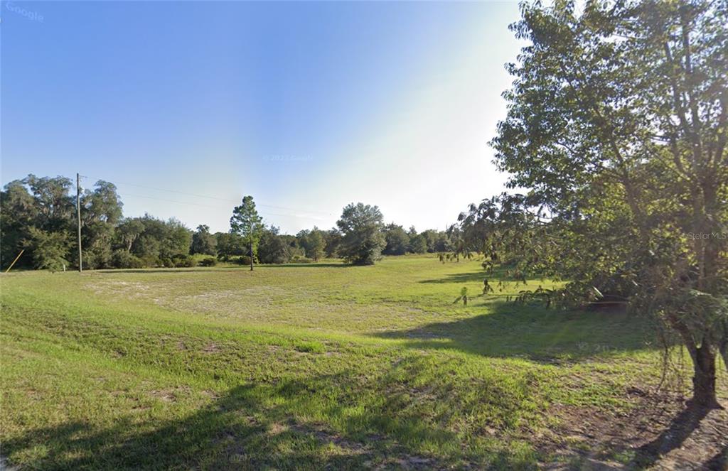 Tbd Commerce Street Bronson, FL 32621 - Photo 6 of 11 a view of a lake with houses in the background