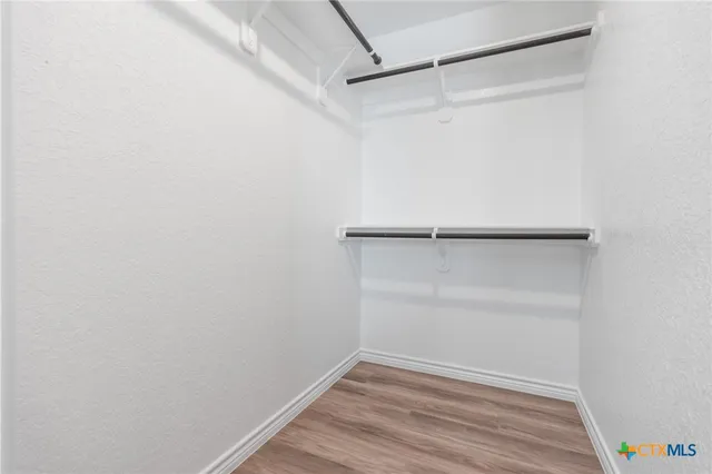 a bathroom with a granite countertop sink a mirror and a shower
