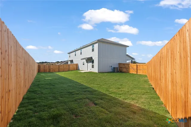 a view of backyard with trampoline