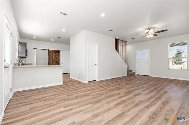 a view of a kitchen with a sink and a microwave