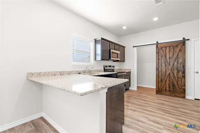 a kitchen with a sink a stove and a refrigerator